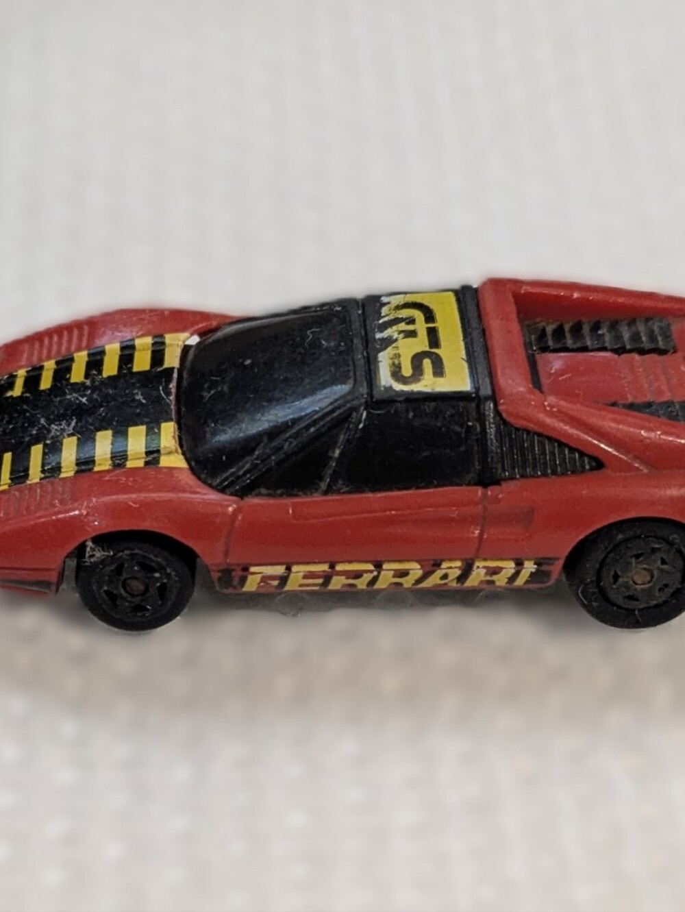 Ferrari Kidco Red Toy Race Car with Black Windshield and Yellow Stripes